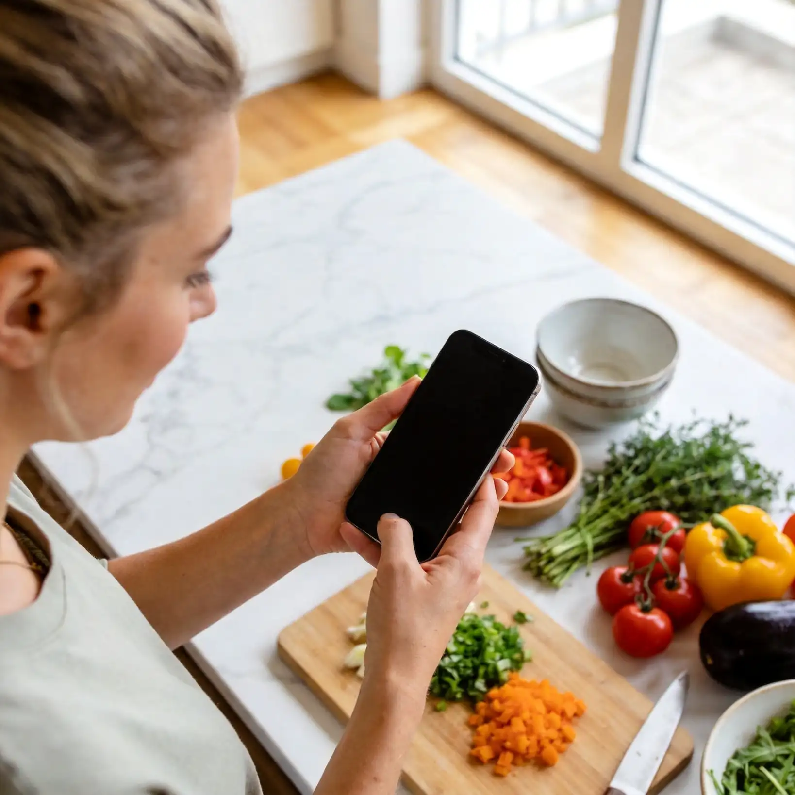 Digital recipe organizer app showing organized recipe collection on a tablet in a modern kitchen