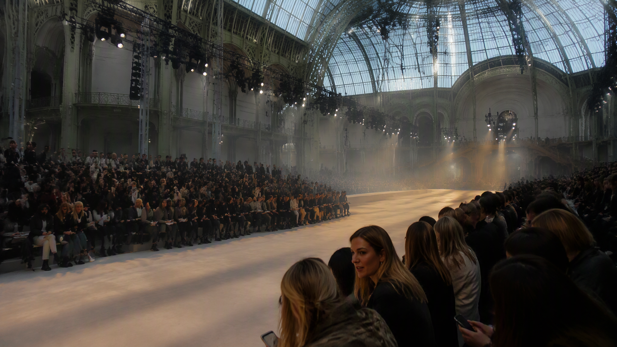 Paris Fashion Week 2026 Wideangle cinematic shot inside a Paris fashion week runway show venue reminiscent of Grand Palais with glass domed ceiling.