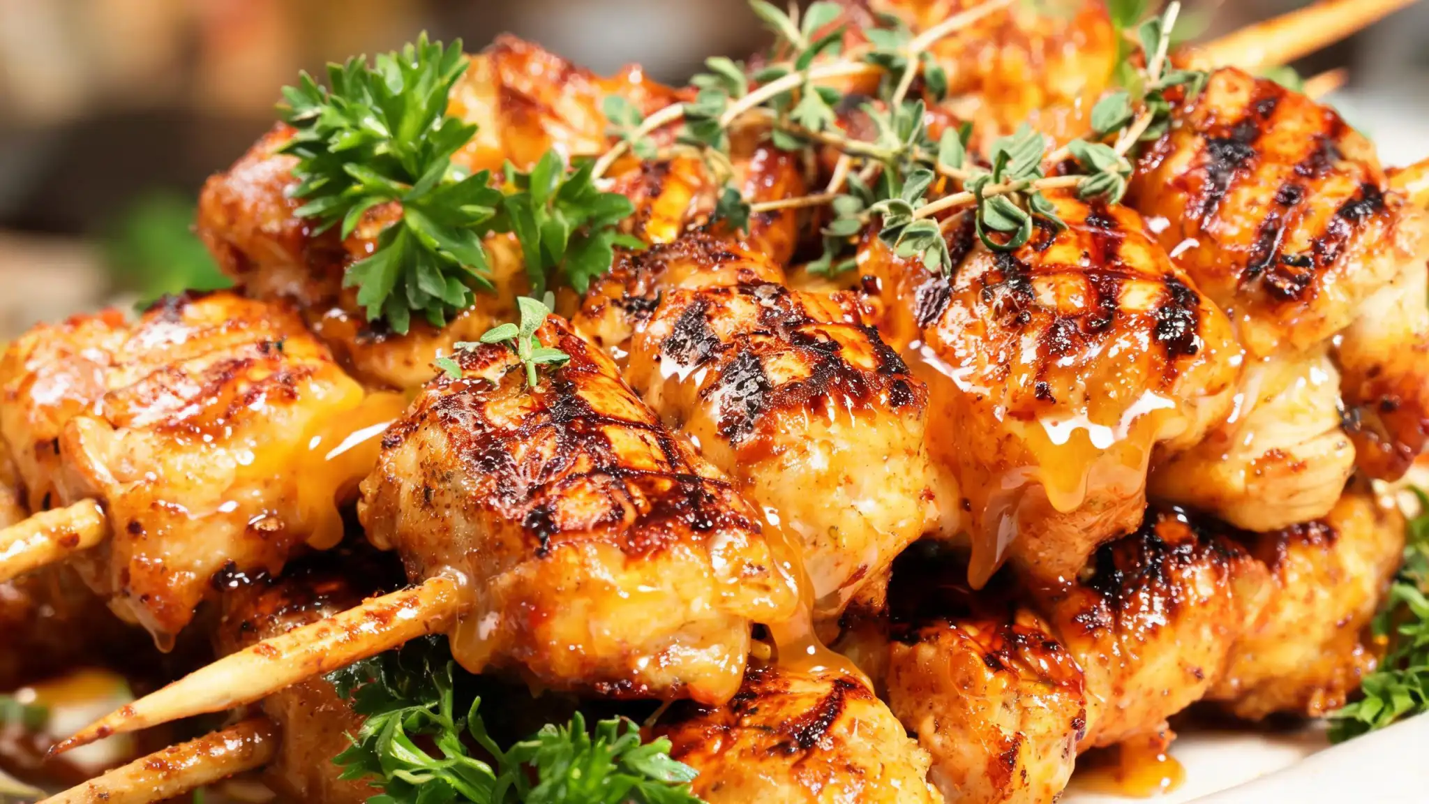 Hot honey grilled chicken skewers on the grill