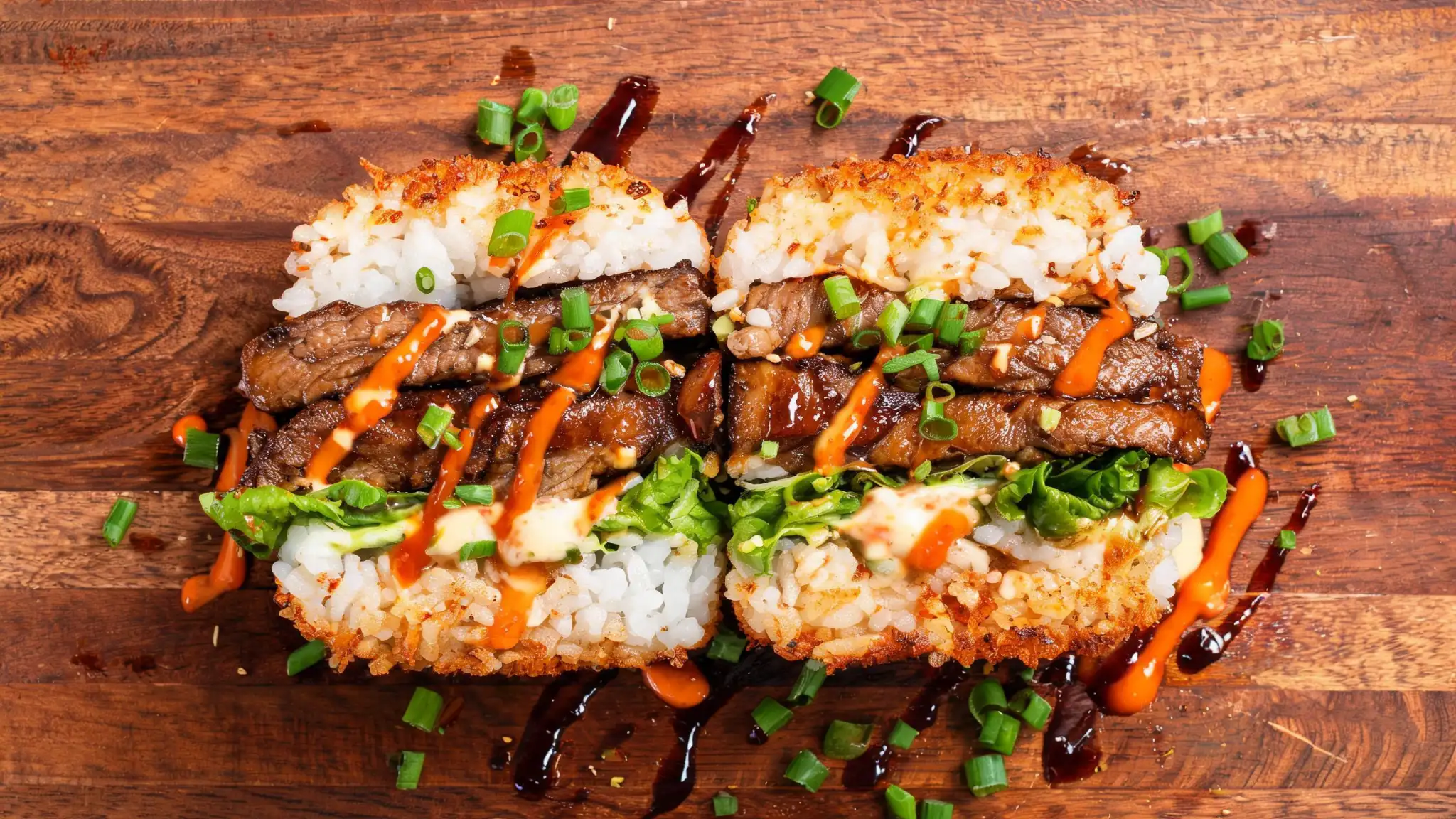 Crispy sushi burger with golden fried rice buns, seared salmon, avocado and spicy mayo